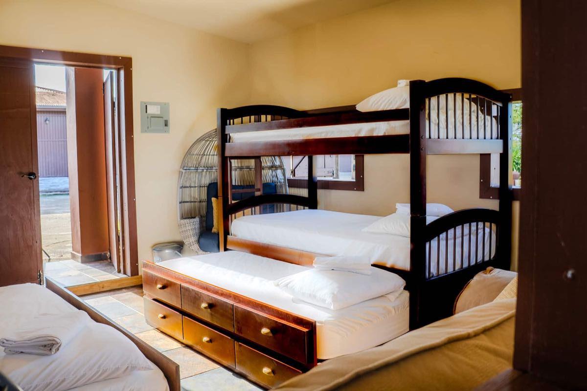 Habitación con varias camas bajo techo de madera